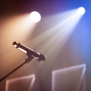 Microphone on stage, symbolizing confidence in singing and performing.
