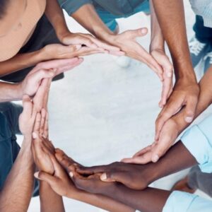 Hands forming a circle with different colors, symbolizing unity, diversity, and connection