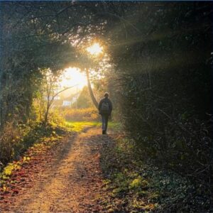 Sunlit pathway, symbolizing a journey toward self-compassion and the message ‘You Are Enough.’