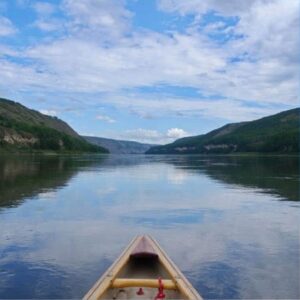 Boat gently floating on a river, symbolizing trust and going with the flow of life