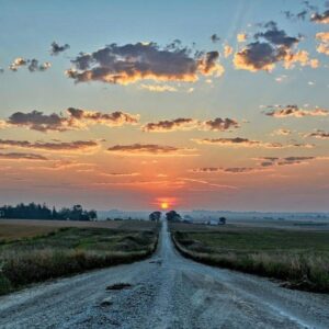 Long road bathed in sunrise light, symbolizing morning motivation, energy, and focus.