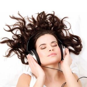 Woman wearing headphones relaxing completely with calm expression