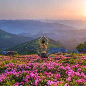 Woman meditating in a flowery field, symbolizing stepping into uncertainty with calm and mindfulness.