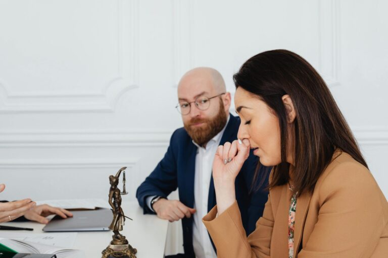 Person in a realistic office or home setting, sitting or standing with a hesitant or frozen expression, reflecting uncertainty or stress.