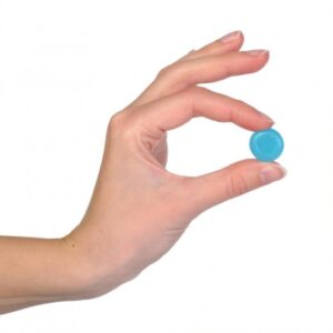 A hand holding a candy, symbolizing relief from headaches or migraines, representing comfort, care, and soothing solutions.