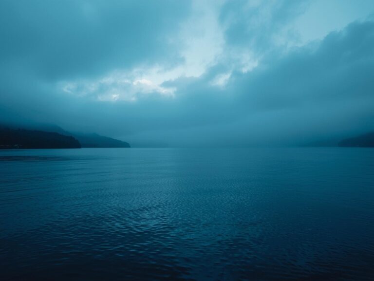 Calm water with gentle ripples gradually smoothing out, symbolizing peace, balance, and the transition from chaos to clarity.