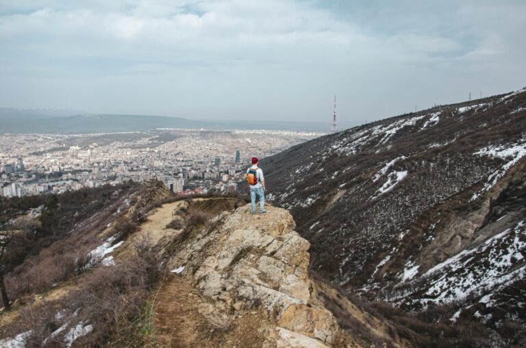 A person standing on a hilltop at sunrise, symbolizing accomplishment, freedom, and personal growth