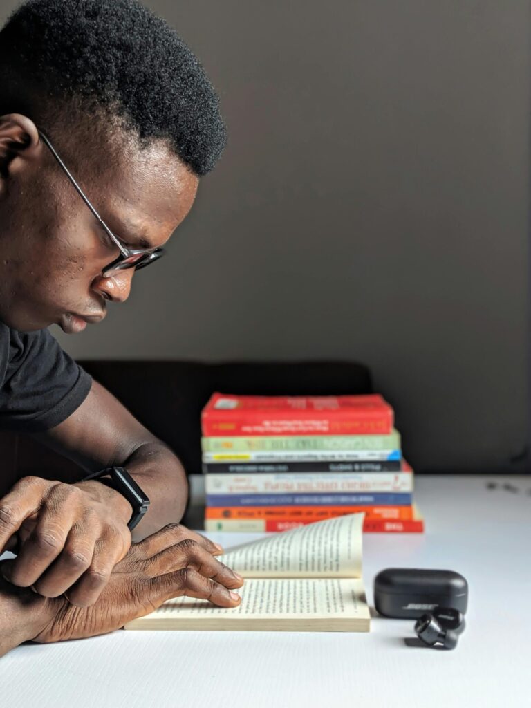 A calm person studying at a desk with gentle light, focused and relaxed.