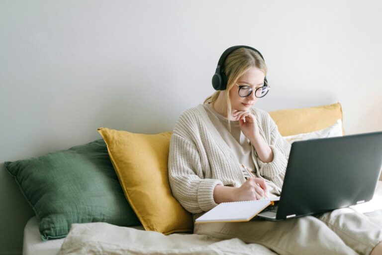 A student sitting calmly at a desk near a window, symbolizing peaceful focus, clarity, and effective study habits supported by hypnotherapy