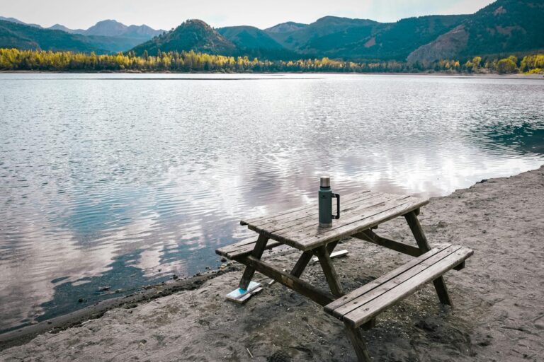 Tranquil nature scene with calm water reflecting the sky, symbolizing peace, balance, and relaxation