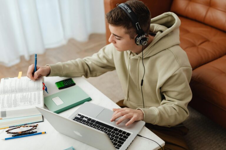 A student sitting at a desk, calmly studying and concentrating, symbolizing focus, confidence, and exam readiness supported by hypnotherapy.