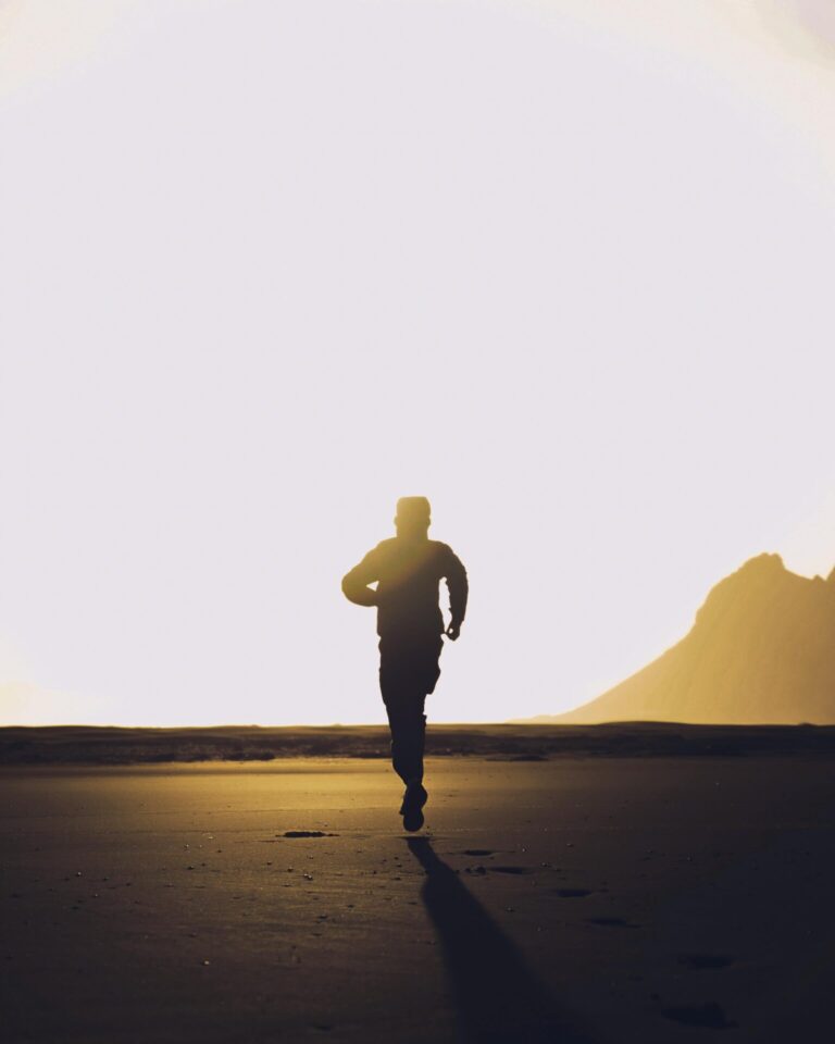 A person running with glowing light trails, symbolizing speed, energy, and momentum.