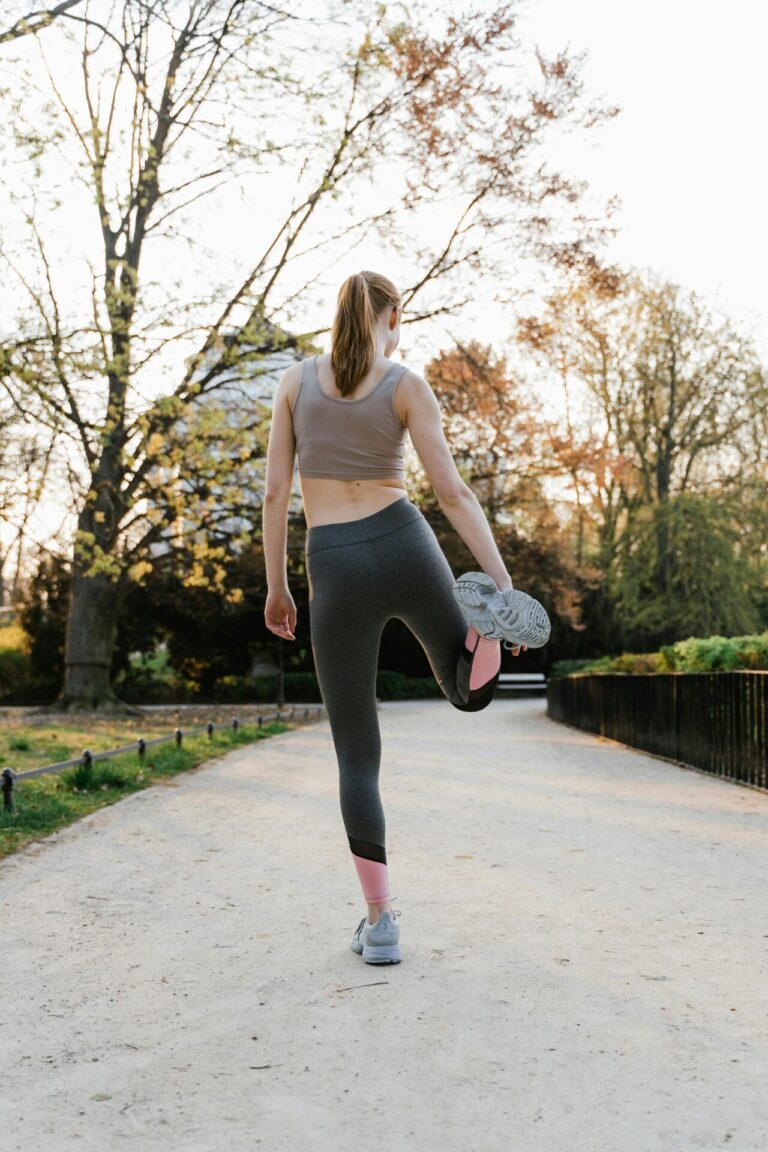 A person running or stretching outdoors, symbolizing vitality, movement, and well-being.