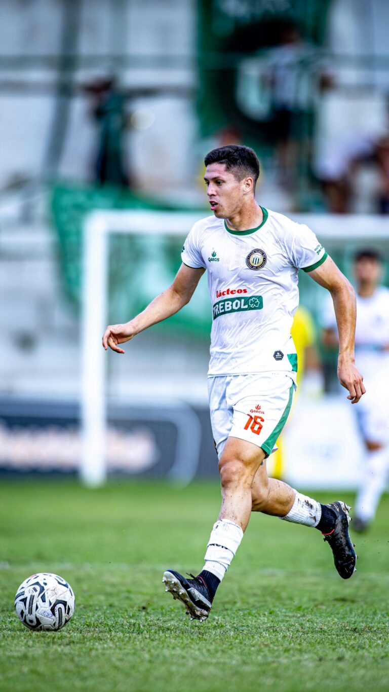 An athlete in mid-action, kicking a soccer ball with power and focus.