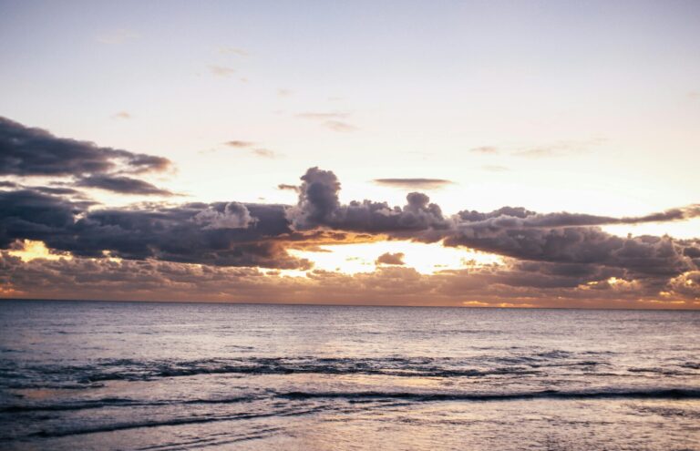 Sunlight softly streaming through clouds, creating a peaceful and hopeful atmosphere.