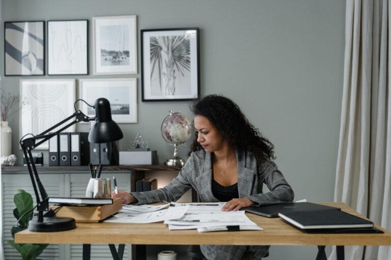 A woman working attentively in front of a computer, surrounded by a calm and organized workspace, symbolizing focus and productivity.