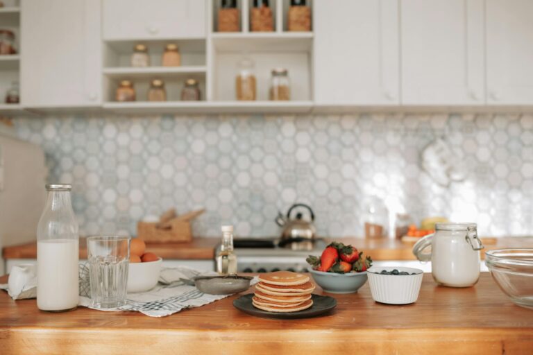 Bright kitchen table filled with everyday foods like cereal, yogurt, salad dressing, and bread, symbolizing balanced nutrition