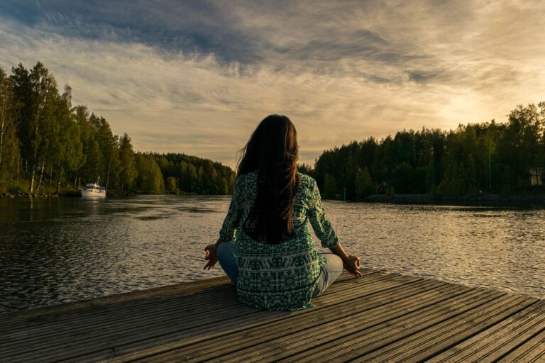 A person sitting calmly in meditation near a sunrise, symbolizing healing, renewal, and self-awareness through hypnotherapy for addiction. Accessing Inner Power