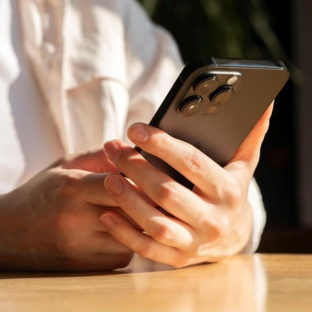 A person thoughtfully using a smartphone with control, symbolizing healthy social media boundaries.