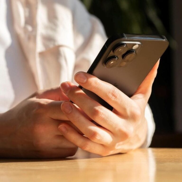 A person thoughtfully using a smartphone with control, symbolizing healthy social media boundaries.