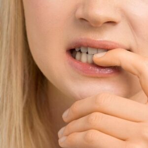 A close-up of hands with nails intact, symbolizing the end of nail-biting habits.