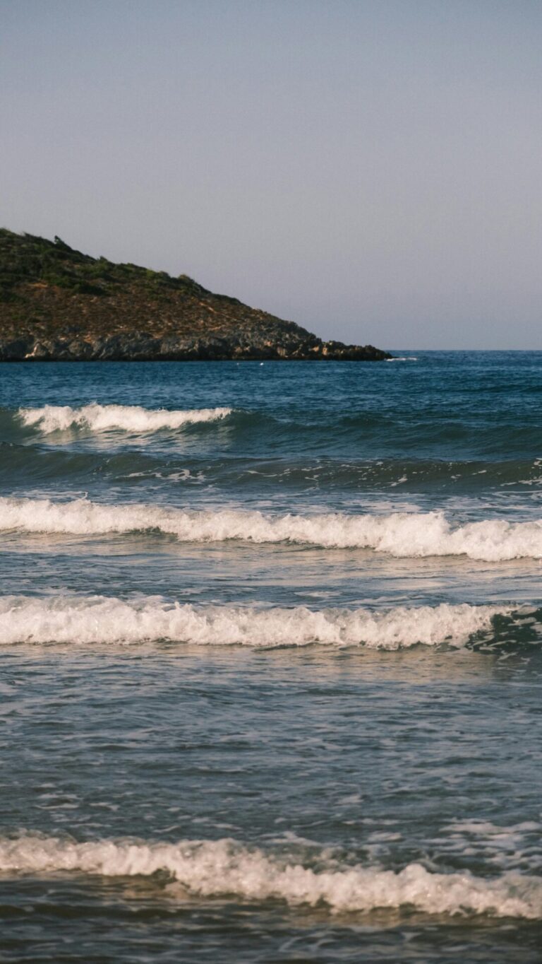 Powerful ocean waves crashing and rolling on the surface of the deep blue sea.