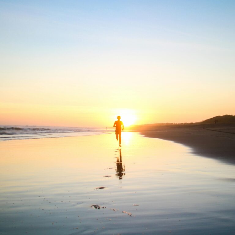 Person walking on the beach - sunset