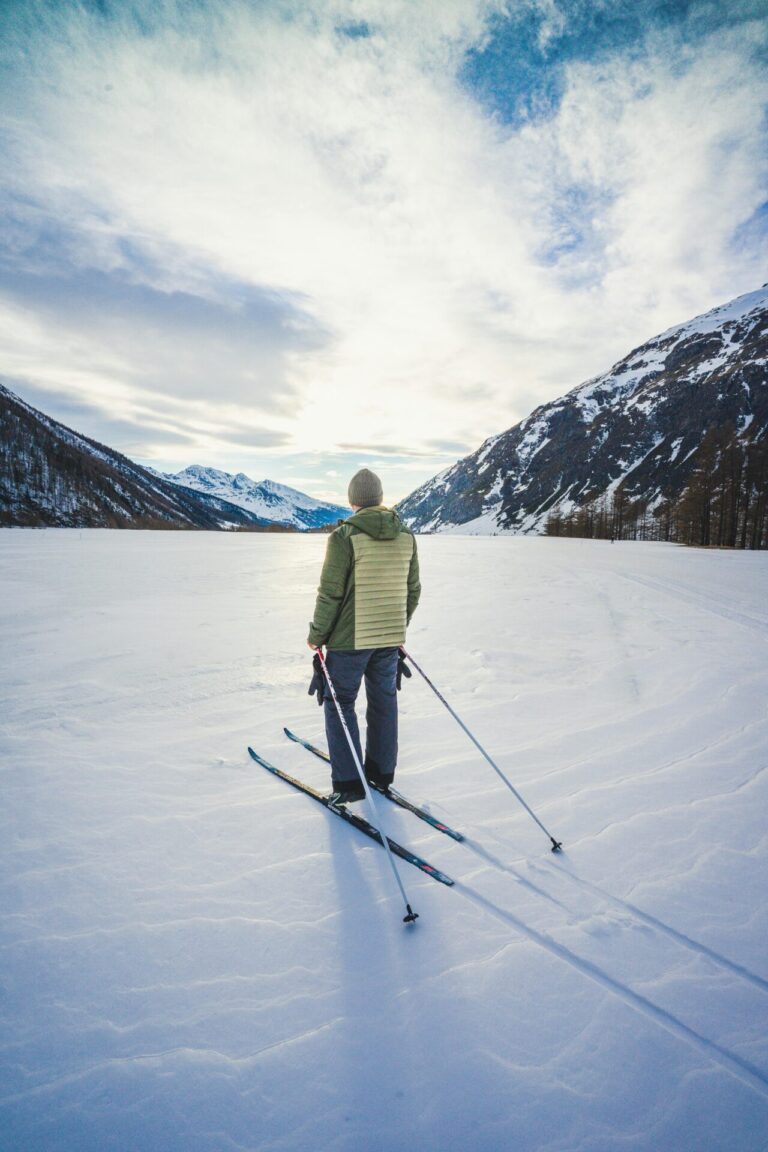 Confident skier standing on a snowy mountain ready to ski
