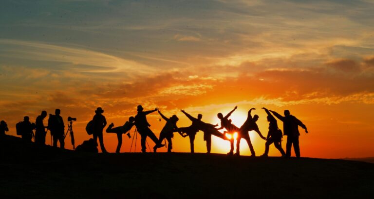 Group of happy people together at sunset, showing social confidence and connection