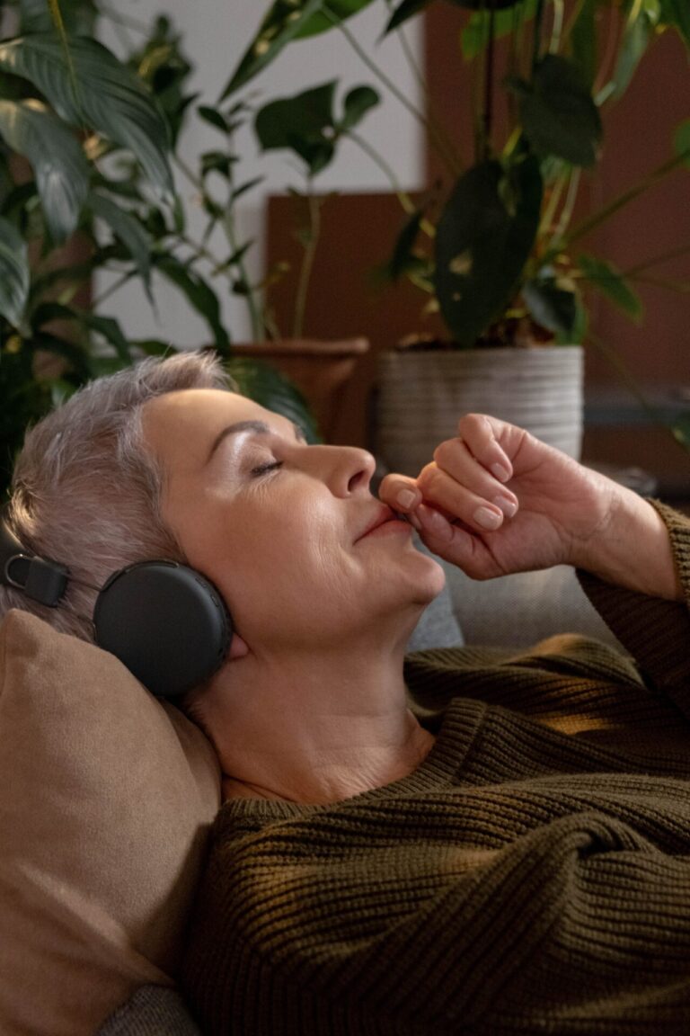Person in a hypnotherapy or guided relaxation session with eyes closed and relaxed posture