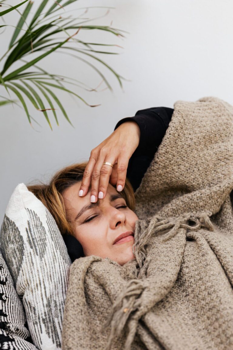Individual checking their forehead as if monitoring temperature or discomfort