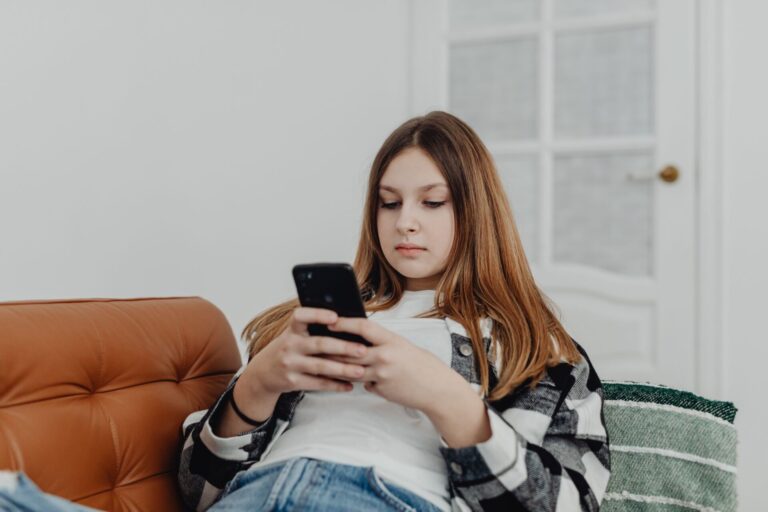 Woman using a phone while setting healthy boundaries for social media and internet use