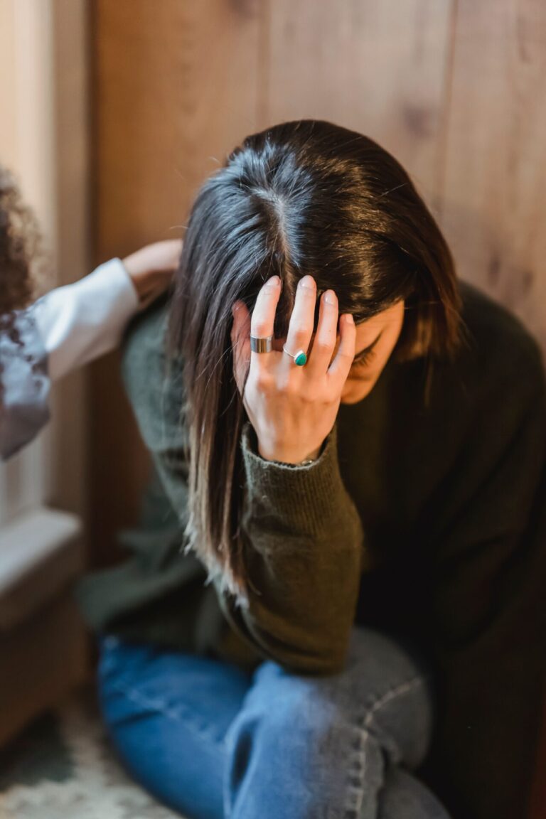 Person displaying body language associated with anxiety and emotional stress