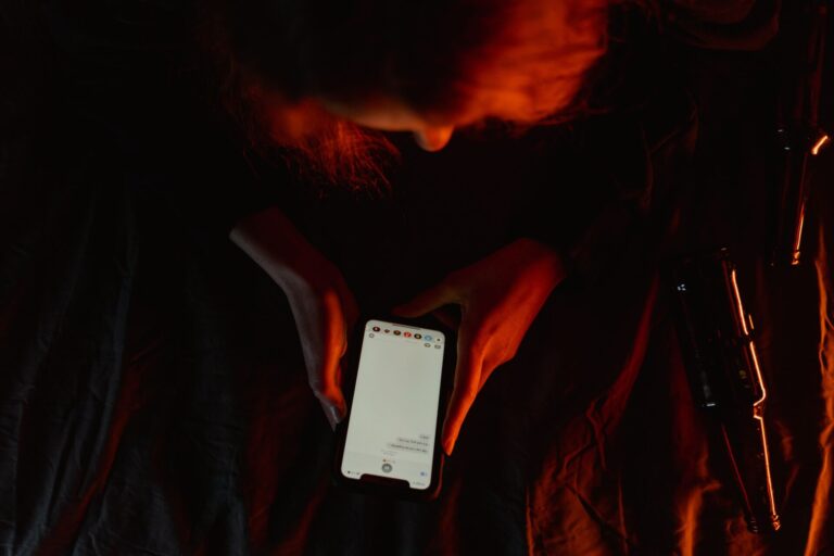 Person in a dark room representing digital addiction and excessive screen use