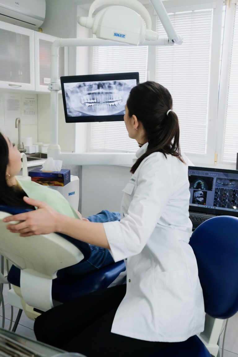 Person sitting in a dental chair during a dental appointment