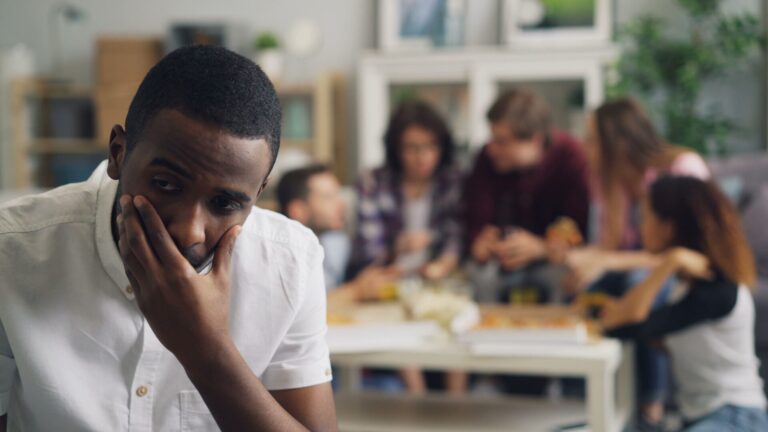 Person sitting alone reflecting and overanalyzing after a social event