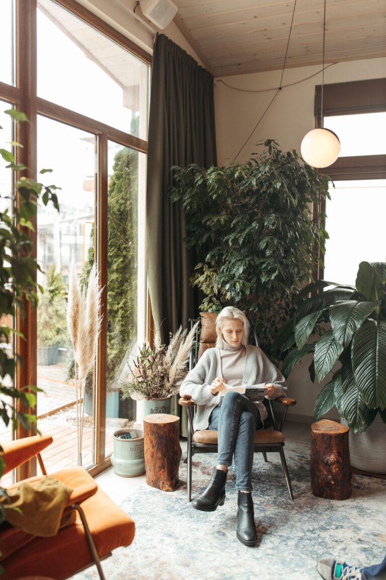 Person sitting peacefully in a natural or cozy indoor setting