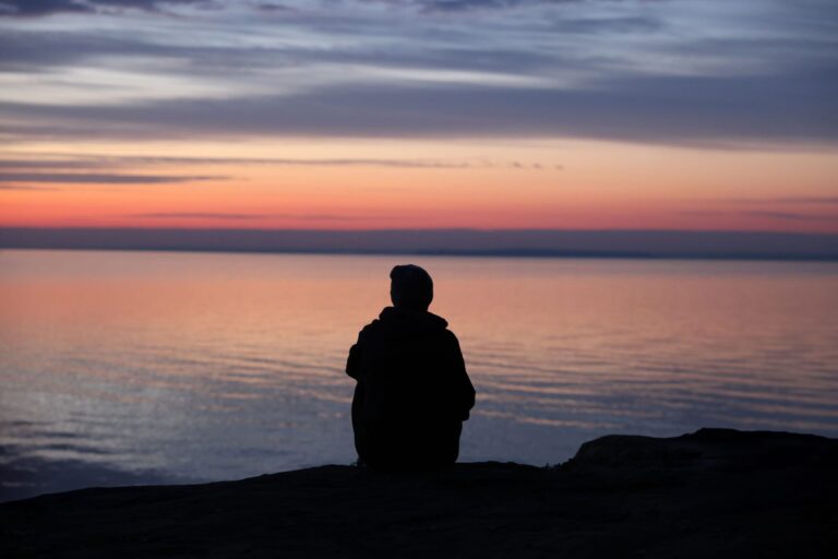 Person sitting peacefully in a calm and relaxing environment