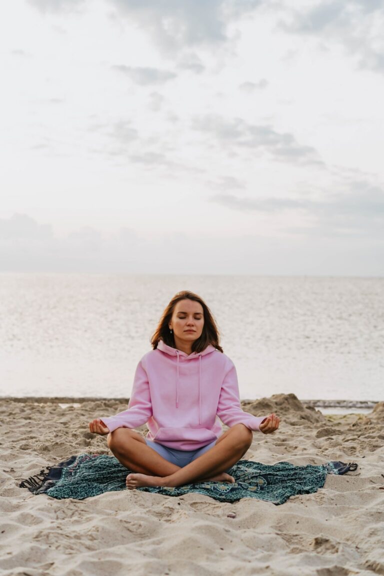 Person sitting peacefully in a natural or cozy indoor setting