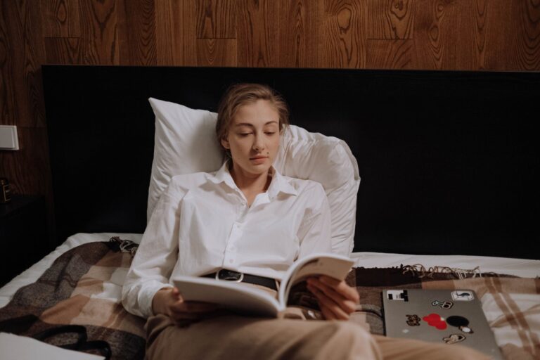 Woman sitting with a book in a calm indoor setting, symbolizing emotional protection and inner peace